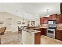 Well-lit kitchen with stainless steel appliances, granite countertops, and a breakfast bar at 4002 Crockers Lake Blvd # 1-128, Sarasota, FL 34238