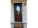 Elegant front door with decorative glass, a 'Welcome' mat, and a modern electronic lock at 4824 16Th St, Zephyrhills, FL 33542