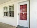 Close up of the condo entrance, featuring a modern door with white frame and red accents at 5150 10Th N Ave # 302, St Petersburg, FL 33710