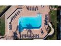 An overhead view showcasing a pristine swimming pool surrounded by lounge chairs and tables, perfect for relaxation and recreation at 6051 Sun Blvd # 111, St Petersburg, FL 33715