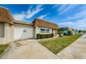 Well-maintained single-story home with a one car garage, manicured landscaping, and a well-maintained lawn at 6935 Monte Carlo N, Pinellas Park, FL 33781