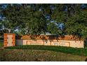 Welcoming entrance sign for Vendome Village, surrounded by lush greenery and mature trees at 6935 Monte Carlo N, Pinellas Park, FL 33781