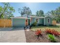 Well-maintained home featuring a fresh exterior paint job and meticulous landscaping at 7311 N Dartmouth Ave, Tampa, FL 33604