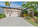 Charming home with a two-car garage and well-manicured landscaping at 8248 Sequester Loop, Land O Lakes, FL 34637