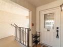 Welcoming entrance to unit 941 with a white door, decorative glass, and charming accents at 8251 Brent St # 941, Port Richey, FL 34668