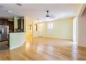 Spacious, open-concept living area with hardwood floors, and natural lighting at 8341 Shallow Creek Ct, New Port Richey, FL 34653