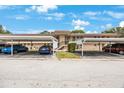 Exterior shot of a condo building with well-lit parking under roof at 9945 47Th Ave N # 203, St Petersburg, FL 33708