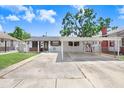 Charming single-story home featuring a covered carport and a well-maintained front yard on a sunny day at 1054 13Th S Ave, St Petersburg, FL 33705