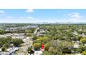Aerial view of a neighborhood with tree coverage and a distant skyline at 1591 S Prospect Ave, Clearwater, FL 33756