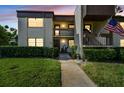 Inviting condo exterior at dusk with well-maintained landscaping, multiple units, and visible unit numbers at 2400 Winding Creek Blvd # 2-201, Clearwater, FL 33761