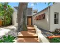 Stunning home with an inviting front door and beautifully landscaped entrance surrounded by rocks and greenery at 326 16Th Ne Ave, St Petersburg, FL 33704