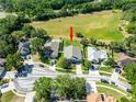 Aerial view of the home, situated on a spacious lot backing to a grassy field at 4007 Canter Ct, Valrico, FL 33596