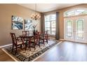 Elegant dining room featuring a chandelier, decorative rug, and double doors at 4007 Canter Ct, Valrico, FL 33596