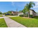 Exterior shot of home with a well-manicured lawn and inviting curb appeal on a sunny day at 4201 Globe Thistle Dr, Tampa, FL 33619