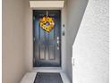Welcoming front door adorned with a vibrant sunflower wreath, enhancing curb appeal at 4201 Globe Thistle Dr, Tampa, FL 33619