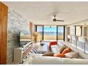 Modern living room with stylish furnishings, and a view of the waterfront from a private balcony at 5940 Pelican Bay S Plz # 1105, Gulfport, FL 33707