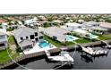 Aerial view of the waterfront home with a private pool, boat dock, and serene water views for luxurious outdoor living at 684 Regatta Way, Bradenton, FL 34208