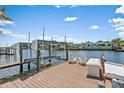 Waterfront property features a private wooden dock and boat lift with space to relax at 1112 38Th Ne Ave, St Petersburg, FL 33704
