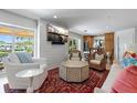 Inviting living room featuring a mounted TV, stylish furniture, and outdoor access at 1112 38Th Ne Ave, St Petersburg, FL 33704