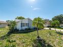 Well-kept lawn and shrubs frame this lovely single-story house with a stone accent wall at 12202 Meadowbrook Ln, Hudson, FL 34667