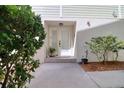 Welcoming front entrance with double doors, a charming porch and lush landscaping at 1353 Curlew Rd, Dunedin, FL 34698