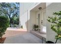 Inviting front porch with seating area and double door entry to the home at 1353 Curlew Rd, Dunedin, FL 34698