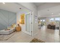 Open-concept foyer featuring tile flooring, unique artwork, and easy access to the kitchen and other living areas at 17923 Cantarina Cv, Bradenton, FL 34211