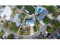 Aerial view of the property showcasing the pool, waterfront access, and surrounding neighborhood at 1827 Venetian Point Dr, Clearwater, FL 33755