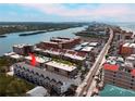 Inviting aerial view of condos with a pool near the beach and waterway, showcasing a coastal lifestyle at 19727 Gulf Blvd # 207, Indian Shores, FL 33785
