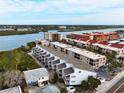 Stunning aerial view of condos with waterfront access and scenic views, nestled among lush greenery, near the beach at 19727 Gulf Blvd # 207, Indian Shores, FL 33785
