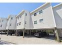 Charming condo complex featuring covered parking and architectural design, providing convenient and stylish coastal living at 19727 Gulf Blvd # 207, Indian Shores, FL 33785