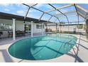 Inviting screened-in pool area with an in-ground pool, patio seating, and a covered lanai at 200 98Th Ne Ave, St Petersburg, FL 33702