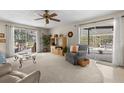 Bright living room with sliding glass doors leading to the screened pool area at 2029 Winding Oaks Dr, Palm Harbor, FL 34683