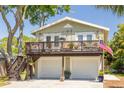 Charming home featuring a 2-car garage, an inviting upper deck, and attractive curb appeal at 224 Ontario Ave, Crystal Beach, FL 34681