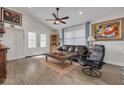 Cozy living room with wood floors, ceiling fan, and plenty of natural light at 224 Ontario Ave, Crystal Beach, FL 34681