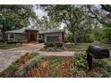 Single story home featuring a brick entrance, large driveway and landscaped yard at 2997 Eagle Estates E Cir, Clearwater, FL 33761