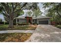 Well-maintained single-story home with a two-car garage and mature landscaping at 2997 Eagle Estates E Cir, Clearwater, FL 33761