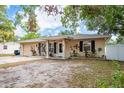 Inviting single-story home with an attached garage, well-maintained landscaping, and a covered entryway at 333 Acropolis Dr, Dunedin, FL 34698