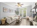 Bright living room features a modern ceiling fan, luxury vinyl plank flooring, and a sliding glass door to the outside at 4221 W Spruce St # 1229, Tampa, FL 33607