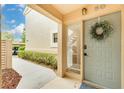 Charming condo front entrance with tasteful decor, inviting pathway, and ample natural light at 50 St Andrews Pl # 50, Oldsmar, FL 34677