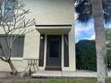 Charming front entrance featuring address numbers, dark door and shutters, and mature landscaping at 501 East Bay Dr. # 2003, Largo, FL 33770