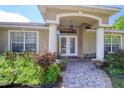 Inviting front entrance with decorative pillars and arched entryway to a double door at 513 Tweed Ave, Seffner, FL 33584