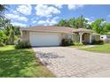 This property boasts a brick paved driveway leading to a 2 car garage. Beautiful home! at 513 Tweed Ave, Seffner, FL 33584