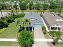 An aerial view showcases the home's mature landscaping, well-manicured lawn, and charming exterior at 5239 Admiral Pointe Dr, Apollo Beach, FL 33572