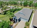Aerial view of a well-maintained single-story home with a lush green lawn and a paver driveway at 5239 Admiral Pointe Dr, Apollo Beach, FL 33572