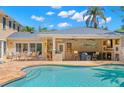 Outdoor pool with an outdoor kitchen and bar area, perfect for entertaining guests at 556 21St Ne Ave, St Petersburg, FL 33704