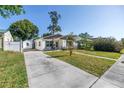 Well-maintained single-story home with a long driveway and a detached shed at 633 47Th N Ave, St Petersburg, FL 33703