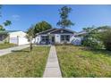 Inviting single-story home with a manicured lawn and walkway leading to the front door at 633 47Th N Ave, St Petersburg, FL 33703