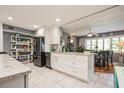Bright and airy kitchen with marble tile flooring, white cabinets and granite countertops at 8198 Terrace Garden N Dr # 411, St Petersburg, FL 33709