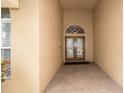 Inviting entryway with a covered porch, decorative glass door, and tiled flooring at 8376 Golden Prairie Dr, Tampa, FL 33647